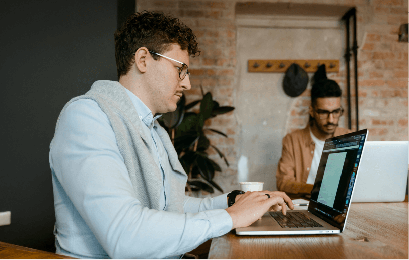 men working on laptops