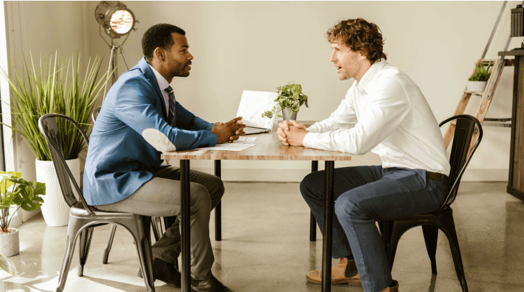 men talking at table