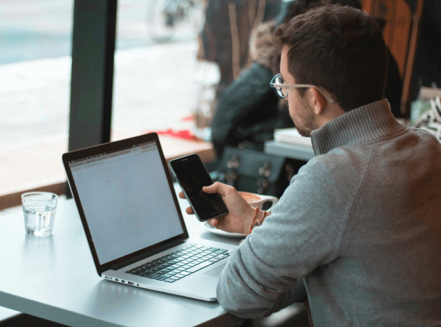 man on phone and laptop