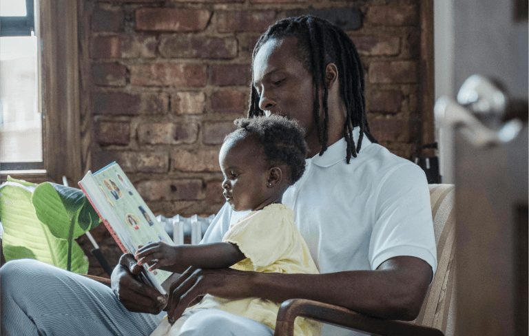 man reading to child