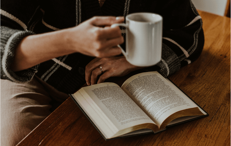 open book with coffee mug